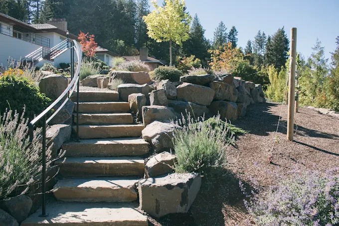Basalt boulder retaining wall with natural stone steps