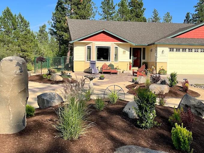Drought-tolerant front yard landscape design with basalt column and boulders